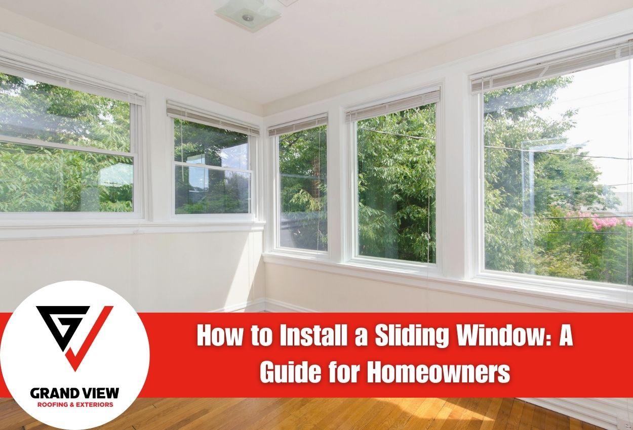 Bright room with large sliding windows overlooking green trees.