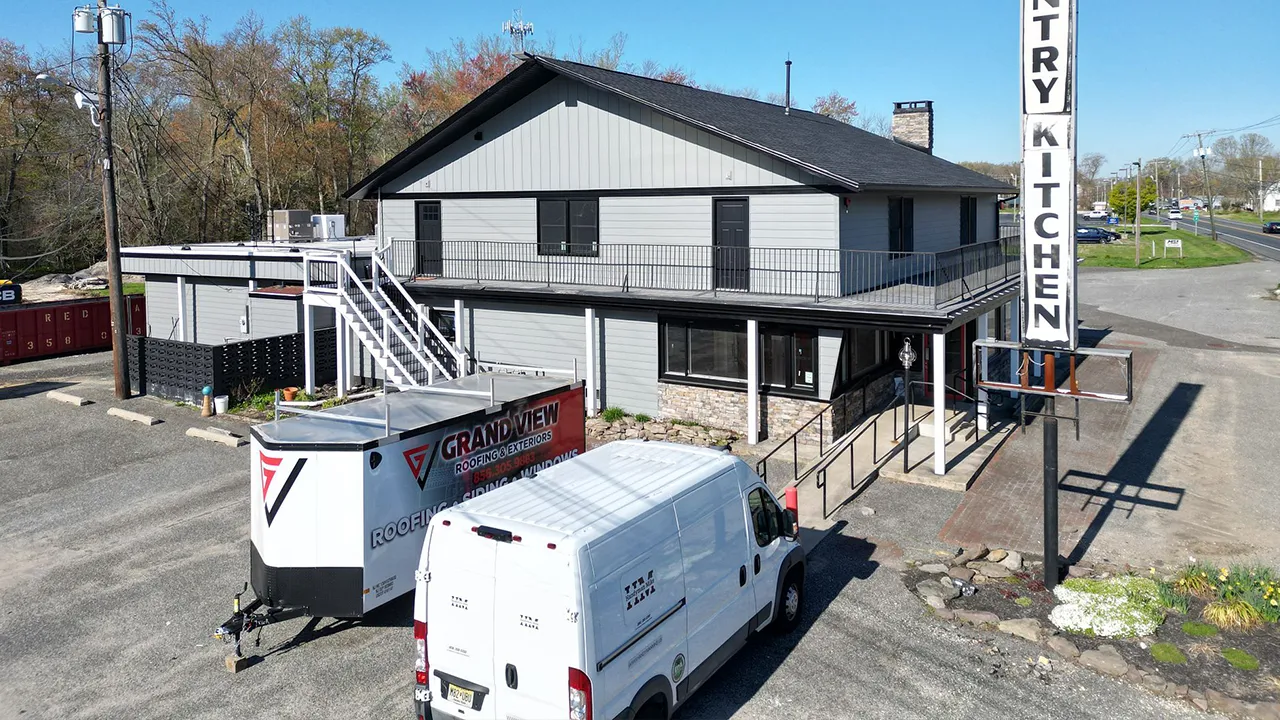Country Kitchen building with roofing company van in foreground