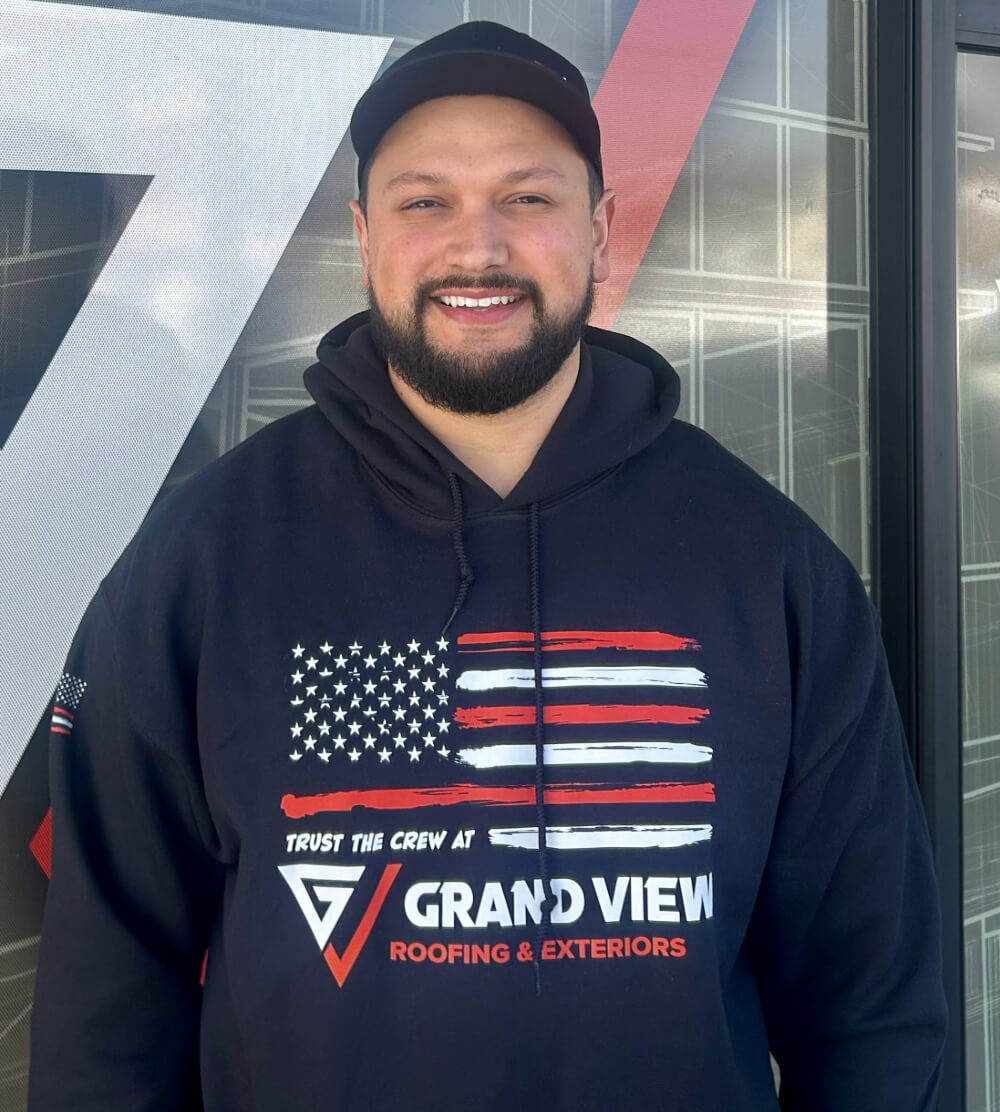 Smiling person in Grand View Roofing & Exteriors hoodie